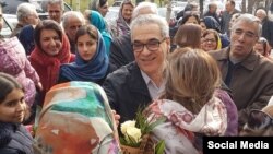 Afif Na'imi stands with loved ones in Tehran earlier today after completing his unjust 10-year prison sentence.