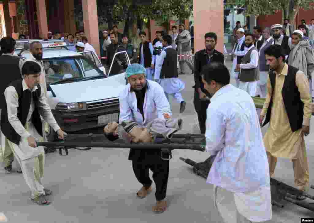 Rescue workers carry an injured child in Jalalabad, Afghanistan.