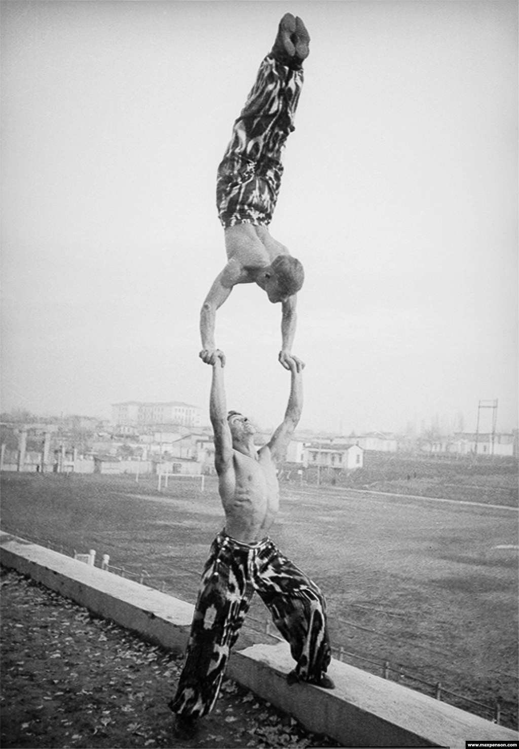 Two acrobats with an arm-quivering display of strength.