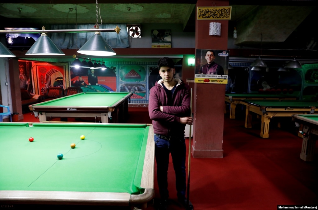 Farzad Aslami, 18, at a snooker club in Kabul. "We want peace for the sake of our country's welfare. We don't want any more suicide attacks and explosions."