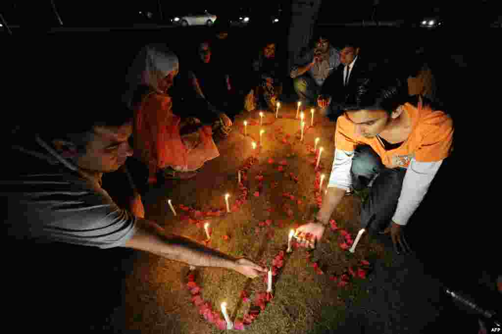 Activists of Pakistani Tehreek-e-Insaf and religious students pray in Islamabad for avalanche victims, including 127 Pakistani soldiers, to show solidarity with victims and their families on April 11.