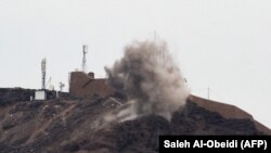 Smoke billows from a hilltop during clashes between fighters from Yemen's southern separatist movement and forces loyal to the Saudi-backed president in the country's second city of Aden, January 28, 2018
