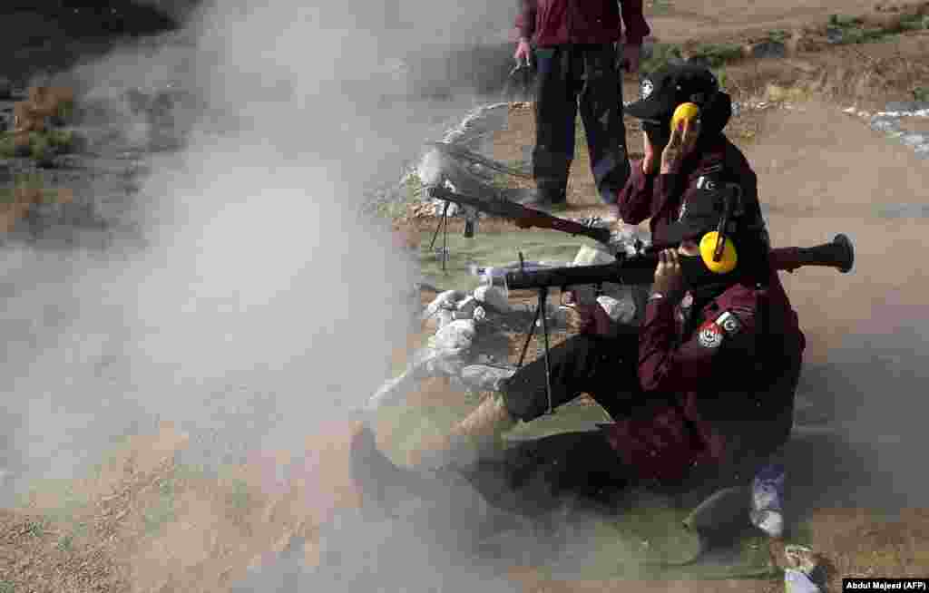 Female Pakistani police commandos use a rocket launcher during an exercise at a police training center in Khyber Pakhtunkhwa Province. (AFP/Abdul Majeed)