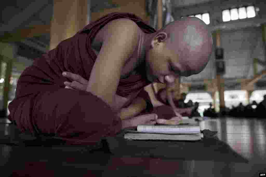 A novice Buddhist monk studies at the Kyat Khat Wine monastery in Bago, Burma (also known as Myanmar). Burma's government has said it "warmly welcomes" the historic visit of U.S. President Barack Obama later this month, expressing hope his trip will bolster the nation's political reform drive. (AFP/Nicolas Asfouri)