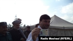 The governor of eastern Khost province, Abdul Jabbar Naeemi, showing his voter registration card.