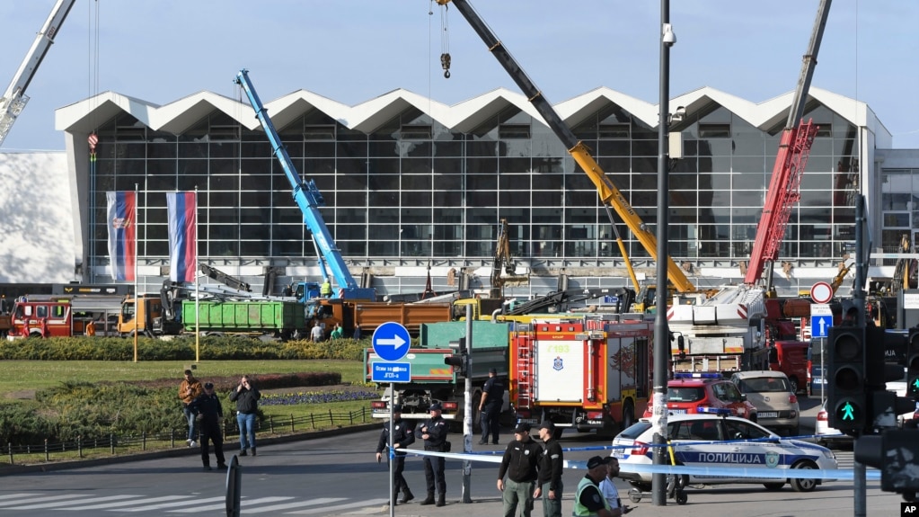 People and rescuers gather at the scene of an outdoor roof collapse at a train station in Novi Sad on November 1.