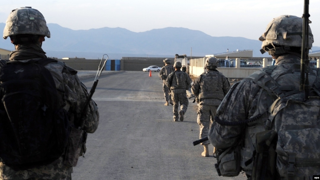 In this U.S. military handout photo, U.S. Army soldiers from Provincial Reconstruction Team-Paktika walk down a street in Sharana, in Afghanistan's Paktika Province, in 2009.