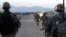 In this U.S. military handout photo, U.S. Army soldiers from Provincial Reconstruction Team-Paktika walk down a street in Sharana, in Afghanistan's Paktika Province, in 2009.