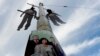 Hanged dummies dangle above a Czech Communist Party election poster in Prague. The dummies are an attempt to remind voters of the political opponents executed by the Communists during their 1948-89 reign. 