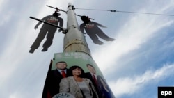 Hanged dummies dangle above a Czech Communist Party election poster in Prague. The dummies are an attempt to remind voters of the political opponents executed by the Communists during their 1948-89 reign. 