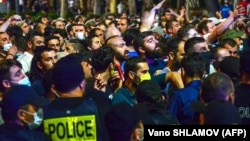 Police officers block counterprotesters in July 2021 during a rally in support of those who were injured when a Pride march was disrupted by violent groups.
