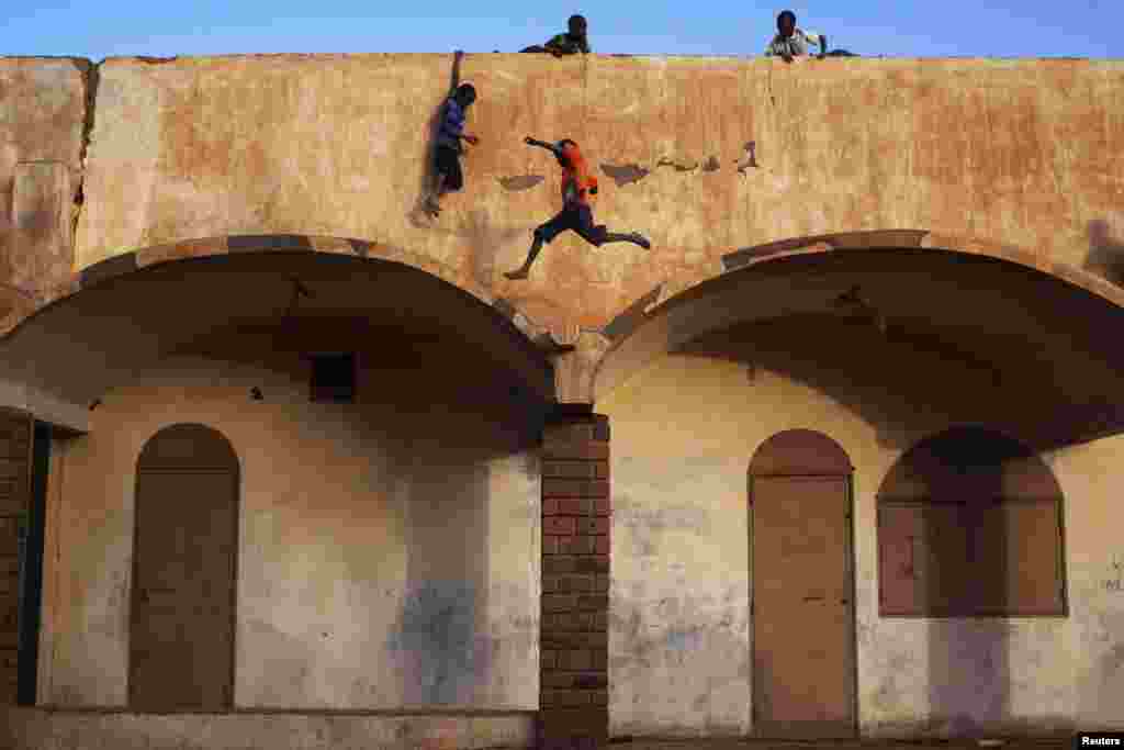 Boys play on the roof of the entrance to a football stadium in Gao, Mali. (Reuters/Joe Penney)