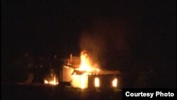 A shop burns in Kyrgyzstan during an outbreak of violence near the border with Tajikistan in May 2014