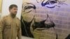 Разман Кадыров на фоне портрета Ахмата Кадырова (архивное фото)