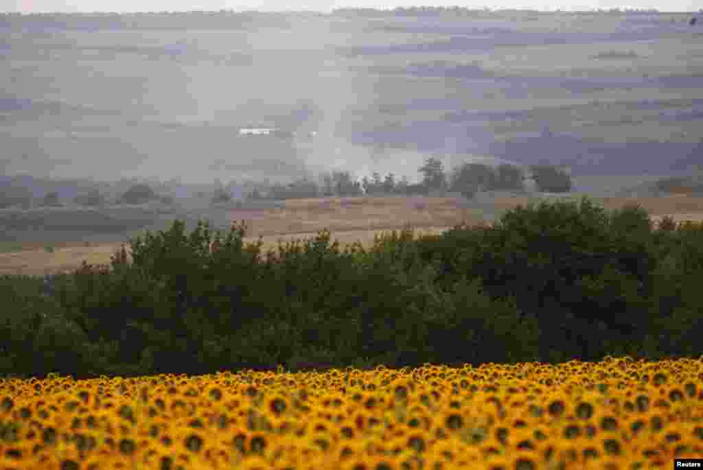 Smoke rises above the site of the Malaysia Airlines Boeing 777 plane crash near the settlement of Hrabove in the Donetsk region on July 17.