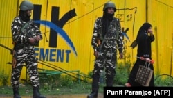 Indian security personnel stand guard near a closed school in Srinagar on August 19.