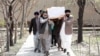 Afghan Sikh men carry a coffin at a funeral of one of the victims of an attack on a Sikh religious complex in Kabul in March 2020.