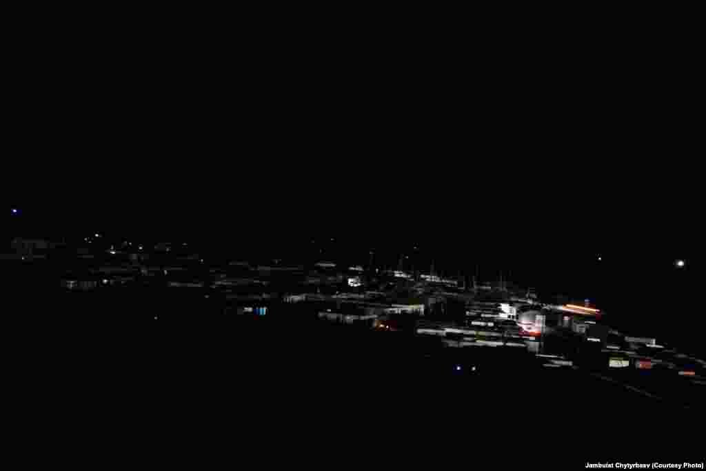 The headlights of a truck coming from China shine on buildings in the town of Murghob, which has only an intermittent electricity supply. The town is often completely dark at night.