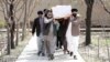 Afghan Sikhs men carry the coffin of one of the victims of a deadly extremist attack on a Sikh religious complex in Kabul that killed dozens of people in late March. 