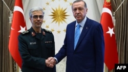 Turkish President Recep Tayyip Erdogan (right) welcomes General Mohammad Hossein Baqeri in Ankara on August 16.