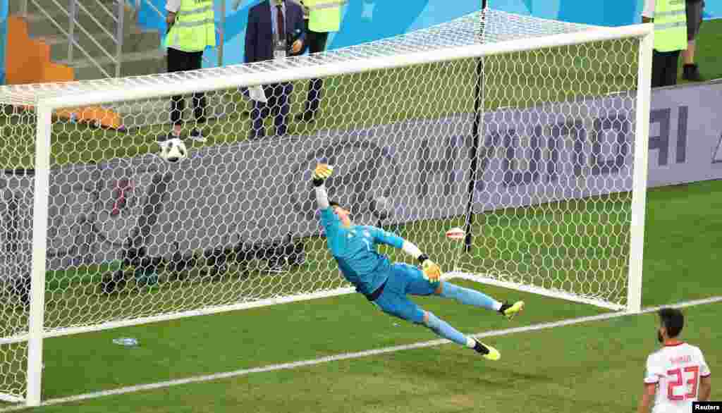 Soccer Football - World Cup - Group B - Iran vs Portugal - Mordovia Arena, Saransk, Russia - June 25, 2018 Portugal's Ricardo Quaresma scores their first goal as Iran's Alireza Beiranvand dives REUTERS/Lucy Nicholson