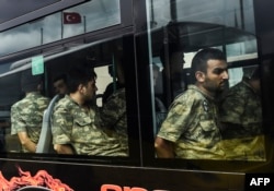 Detained Turkish soldiers who allegedly took part in a military coup arrive in a bus at the courthouse in Istanbul on July 20.