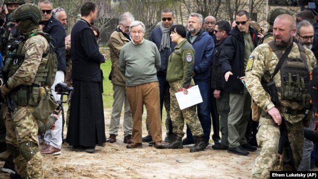 UN Secretary-General Antonio Guterres (center) stands at the site of a mass grave in Bucha, on the outskirts of Kyiv, during a visit on April 28.