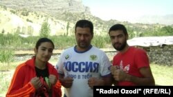 FILE: Tajik boxer Mavzuna Chorieva with her trainer Balanov.