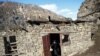 Patimat Musalmagomedova throws dirty water out of her house in Khyurdabakh, in the mountains of Daghestan. She is the last permanent resident of the village.