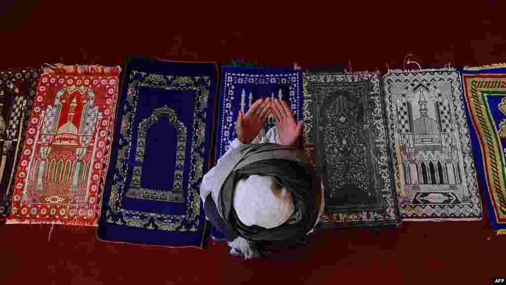 A man prays at a historic mosque in Afghanistan&#39;s Samangan Province, north of Kabul, during the holy month of Ramadan. (AFP/Qais Usyan)