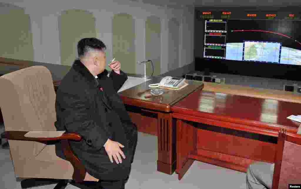North Korean leader Kim Jong Un smokes a cigarette while monitoring events at the General Satellite Control and Command Center after the launch of the Unha-3 rocket that carried a satellite into polar orbit on December 12. (Reuters/KCNA News Agency)