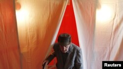 A voter leaves a booth at a poling station in the village of Dorotskaya during Moldova's referendum on September 5.