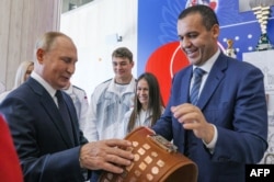 Президент Росії Володимир Путін (ліворуч) і президент Міжнародної асоціації боксу (AIBA) Умар Кремльов оглядають новий Міжнародний центр боксу в спорткомплексі «Лужники». Москва, 10 вересня 2022 року