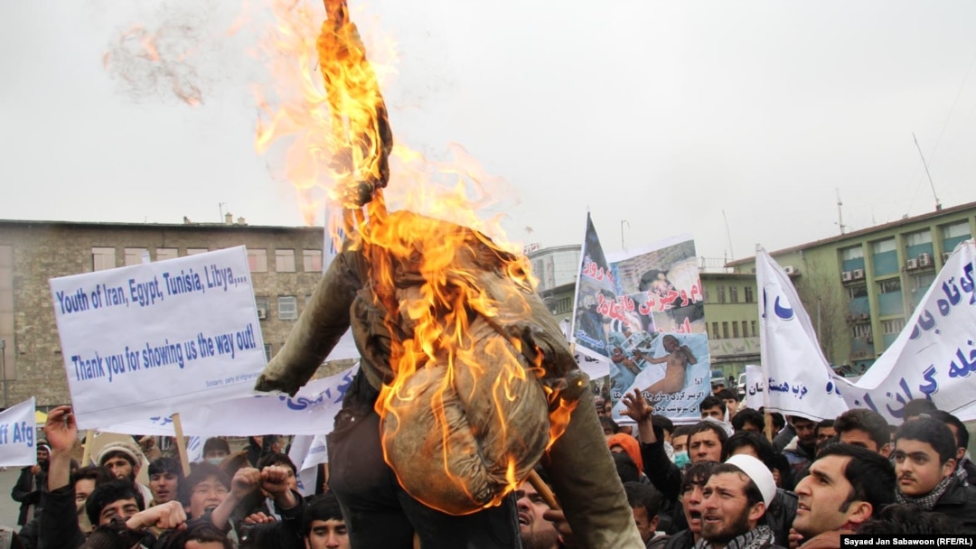 Afghan protesters burn an effigy of U.S. President Barack Obama. With just three years before the West hands off full control of the country's security, questions remain over Afghanistan's political maturity.