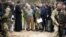 UN Secretary-General Antonio Guterres (center) stands at the site of a mass grave in Bucha, on the outskirts of Kyiv, during a visit on April 28.