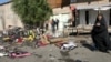 A woman mourns at the site of a bomb explosion in a Baghdad market in early November