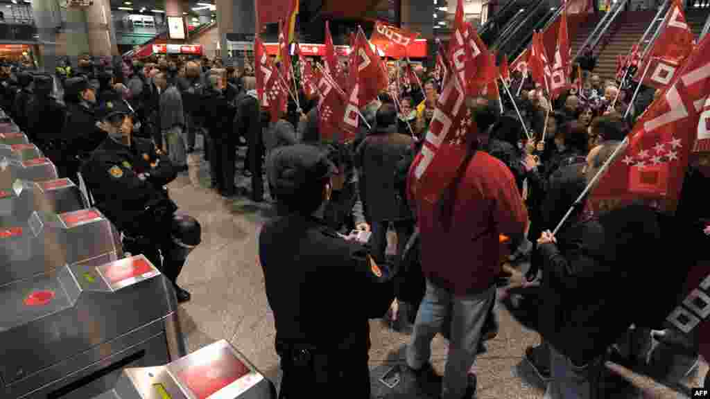 Workers demonstrate during a general strike at the Atocha train station in Madrid, Spain.