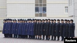 FILE: Kazakhstan's railway staff line up to welcome foreign diplomats at a border crossing with China.