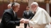 Pope Francis (right) shakes hands with Hungarian Prime Minister Viktor Orban at Romanesque Hall in the Museum of Fine Arts in Budapest on September 12.