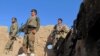 Afghan National Army (ANA) soldiers stand at an outpost in Helmand on December 20.