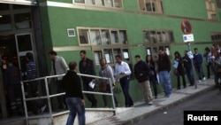 People wait in line to enter a government job center in Malaga, Spain. (file photo)