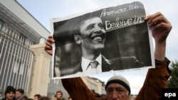 A man holds a sign investing hope in U.S. President Barack Obama at a Georgian opposition rally in Tbilisi in November 2008.