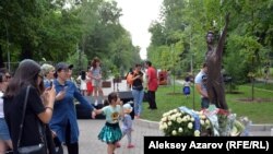 Памятник Денису Тену и цветы у его подножия, принесенные участниками торжественного открытия. Казахстан, Алматы, 22 июня 2019 года.