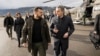 Ukrainian President Volodymyr Zelensky (left) is welcomed by Swiss Foreign Minister Ignazio Cassis upon his arrival at Bern airport on January 15.