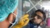 A paramedic wearing protective gloves takes a nose-swab sample to be tested for the coronavirus in Karachi.