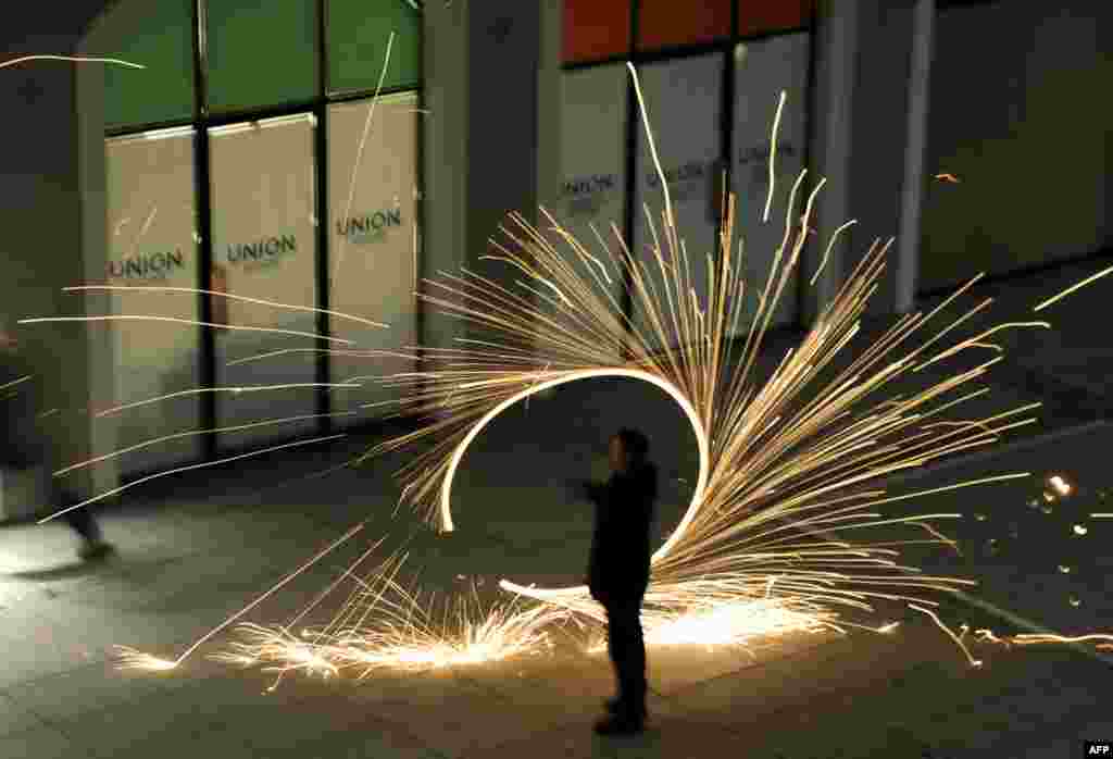 A supporter of the opposition Self-Determination party twirls firecrackers in the second runoff of local elections in Pristina. (AFP/Armend Nimani)