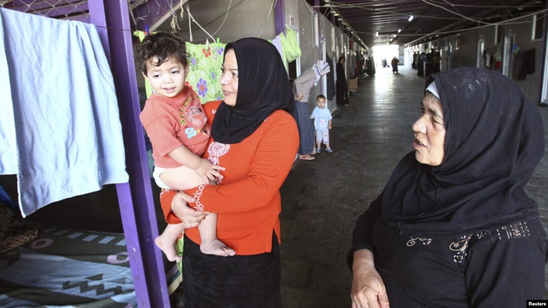Syrian refugee women wait for the arrival of UN-Arab League peace envoy for Syria at their camp in the border town of Altinozu in Hatay province on September 18.