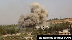 Smoke billows following a reported Russian air strike in the mostly rebel-held Syrian province of Idlib on September 20. 