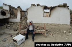 Чоловік сидить перед зруйнованим будинком у селі Кок-Терек, біля киргизько-таджицького кордону, 5 травня 2021 року