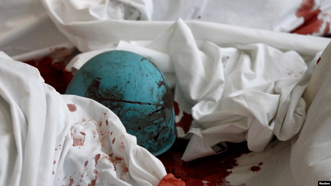The helmet of a dead antigovernment protester lies on bloody sheets in the lobby of the Hotel Ukraine.